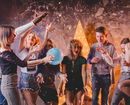 friends-throwing-up-champagne-confetti