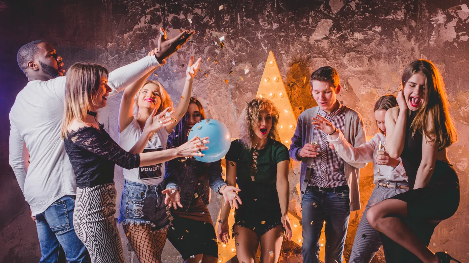 friends-throwing-up-champagne-confetti